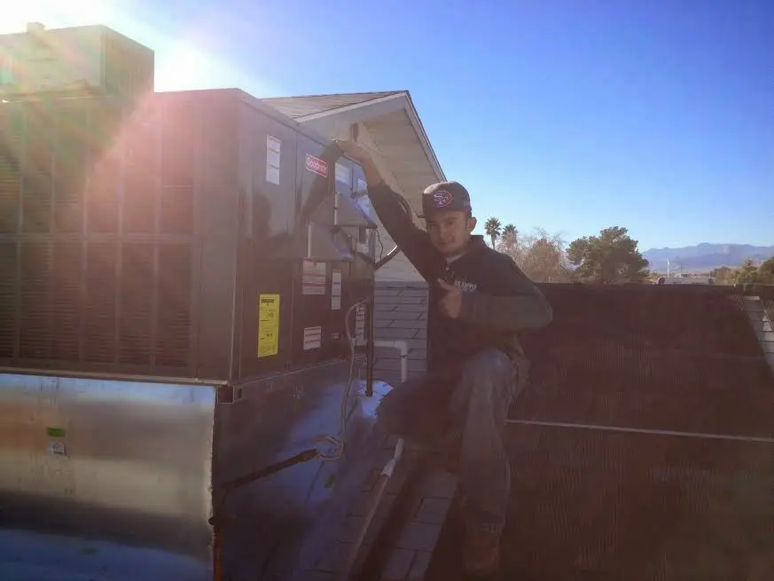 HVAC technician performing HVAC Inspection on a rooftop unit in San Pablo